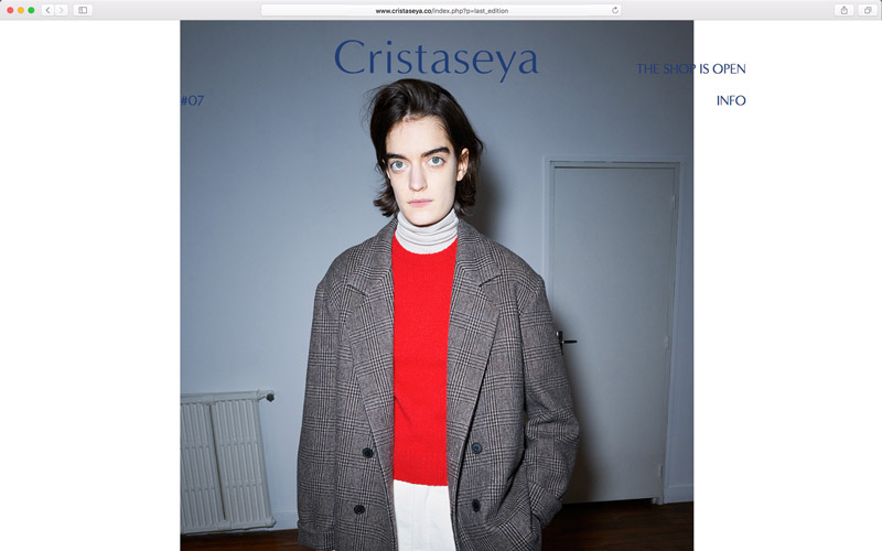 Cristaseya, website design, screen from edition 7 with a model wearing a wool brown jacket and red wool sweater, photo by Andrea Spotorno